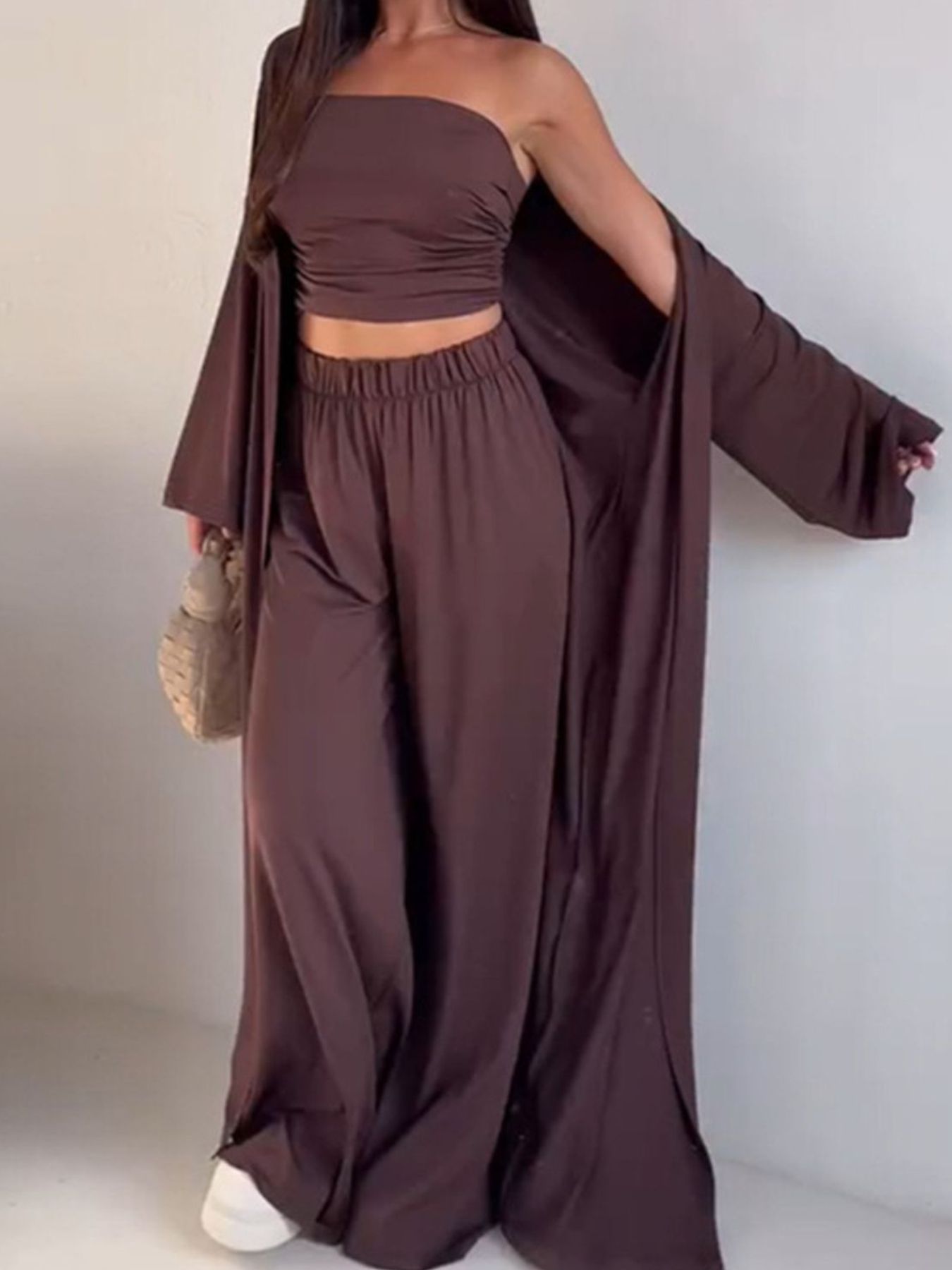 Dark brown three-piece outfit set with ruched tube top, wide-leg pants, and open cardigan.