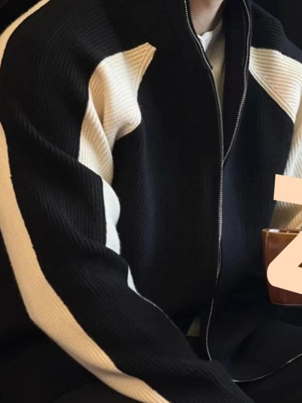 Black and cream contrast panel ribbed zip-up track jacket with a full zip closure.