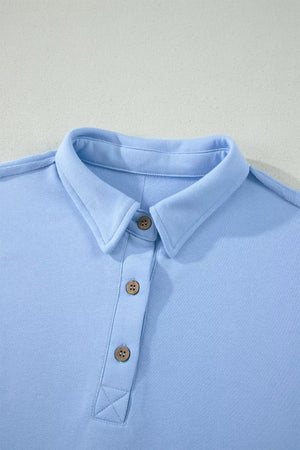Light blue sleeveless polo shirt with wooden buttons and collar detail