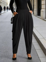 Black ribbed plus size maternity pants with a high waist and pleated detail.