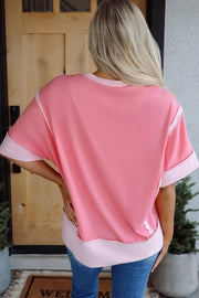 Pink t-shirt with contrasting light pink trim on neckline, sleeves, and hem.