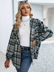 Oversized hooded shacket in deep teal plaid with snap closure, styled open over a white turtleneck.