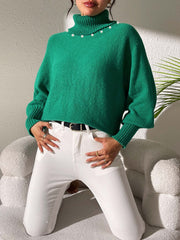 Green knit sweater with pearl details on the neckline and dolman sleeves.