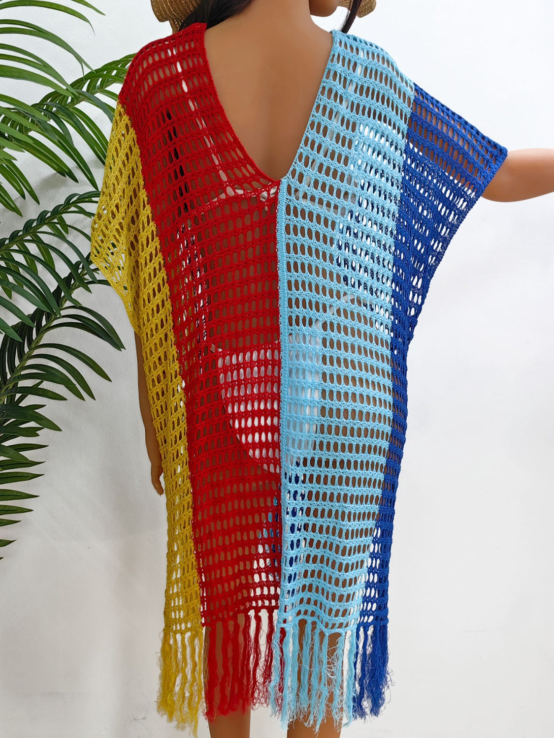 Colorblock crochet cover-up with fringe in yellow, red, and blue.