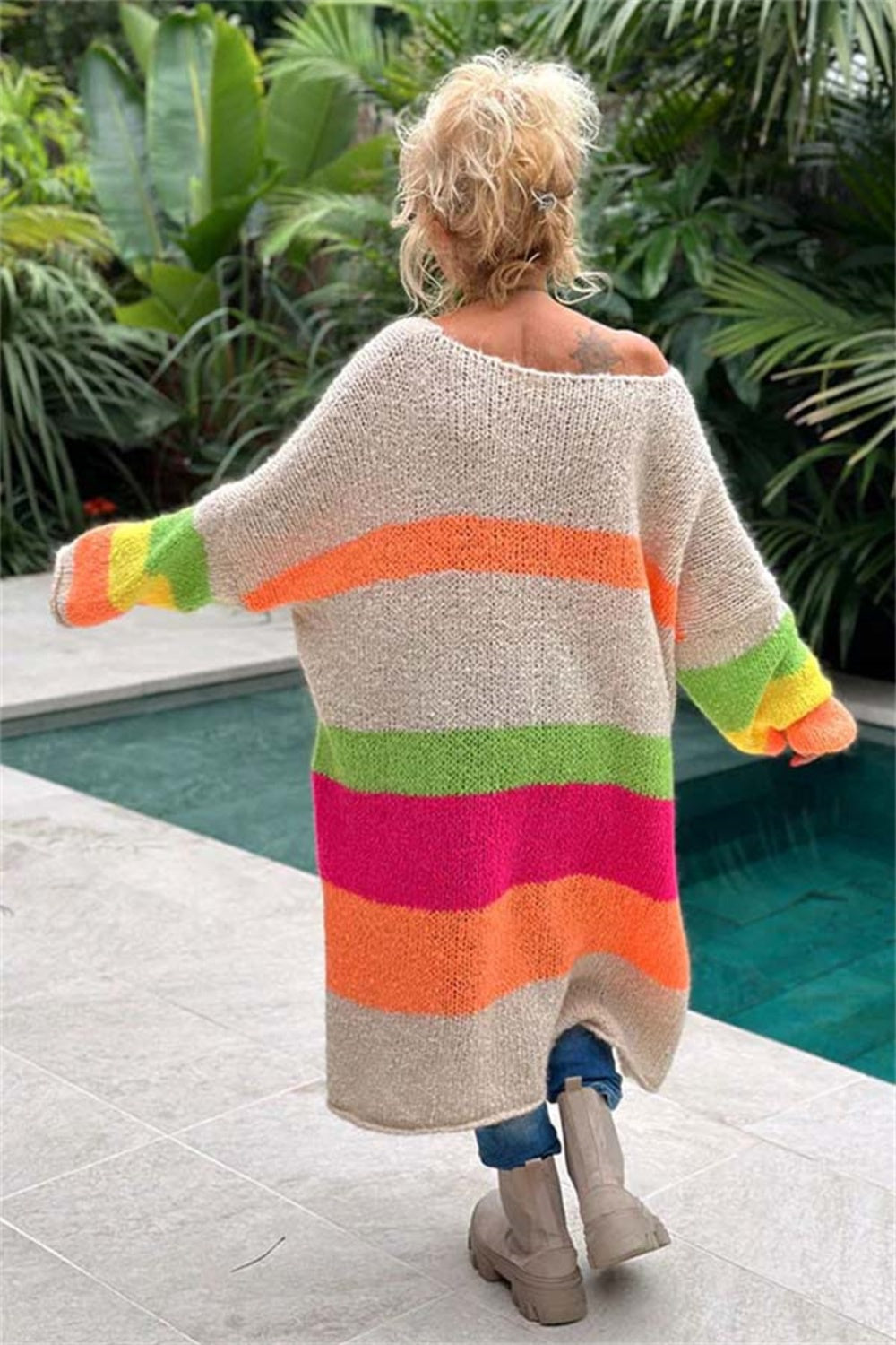 Beige midi sweater dress with rainbow stripes, off-the-shoulder neckline, and long sleeves.
