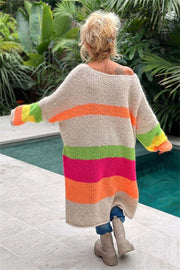 Beige midi sweater dress with rainbow stripes, off-the-shoulder neckline, and long sleeves.