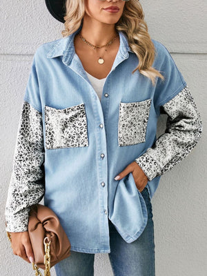 Denim shirt with leopard print sleeves and pockets, button-up, casual style.