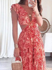 Elegant ruffled V-neck maxi dress in pink paisley print with cut-outs and a wooden ring detail.