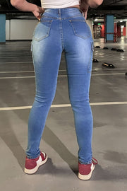 Medium wash skinny cargo jeans with a cotton blend, shown from the back.
