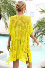 Yellow open-knit caftan with side tie detail and tassels, acrylic material.