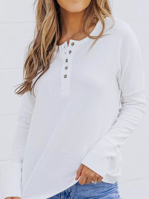 White textured cotton henley shirt with button detail and long sleeves.