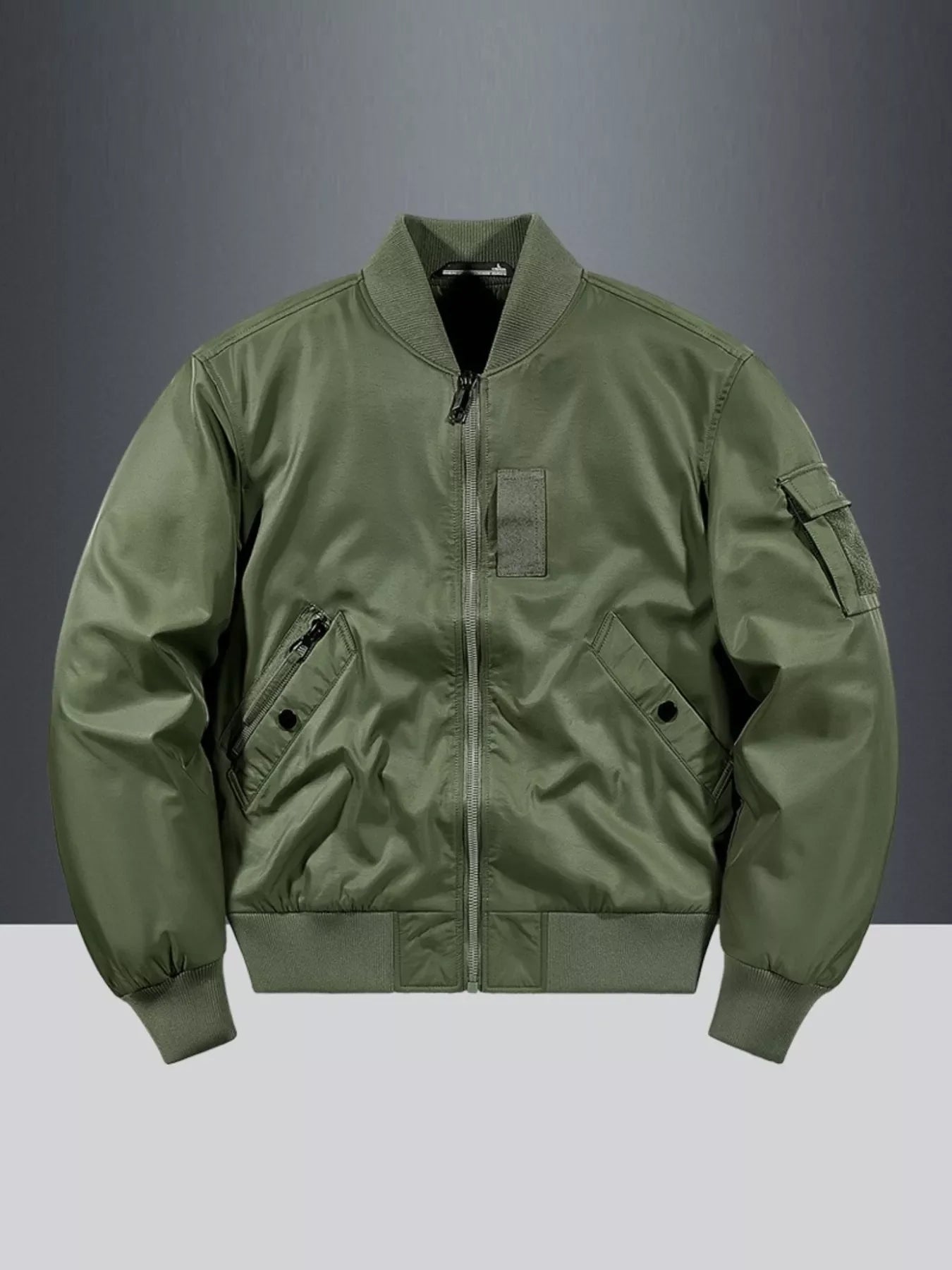 Military green bomber jacket with zip closure, utility pocket, and ribbed cuffs.