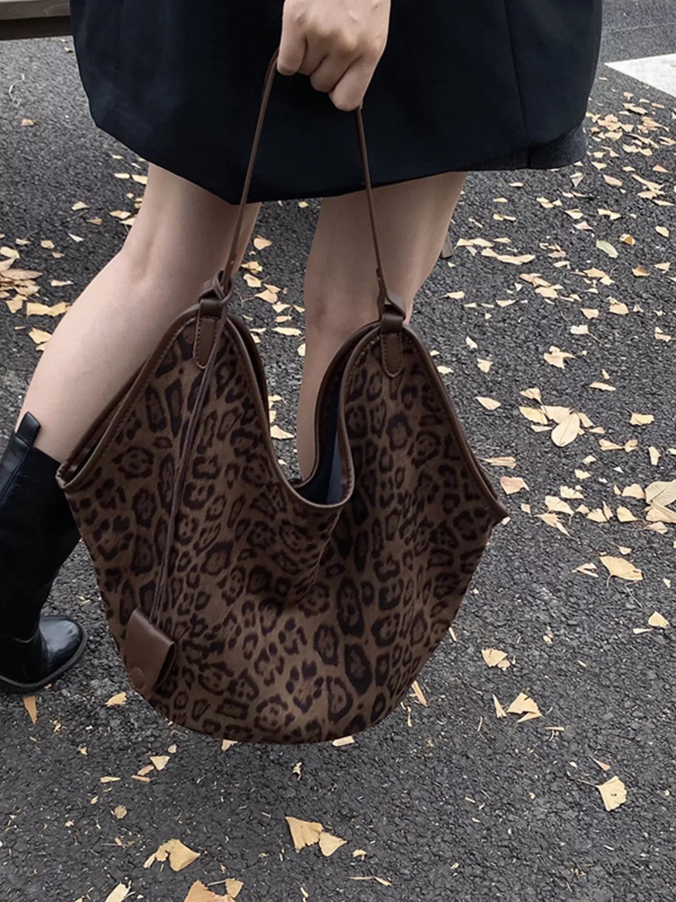 Chic leopard print tote bag in brown with dual shoulder straps and a slouchy silhouette.