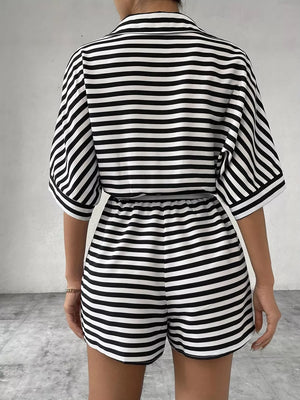 Black and white striped belted romper with collared button-front top and elastic waist shorts.