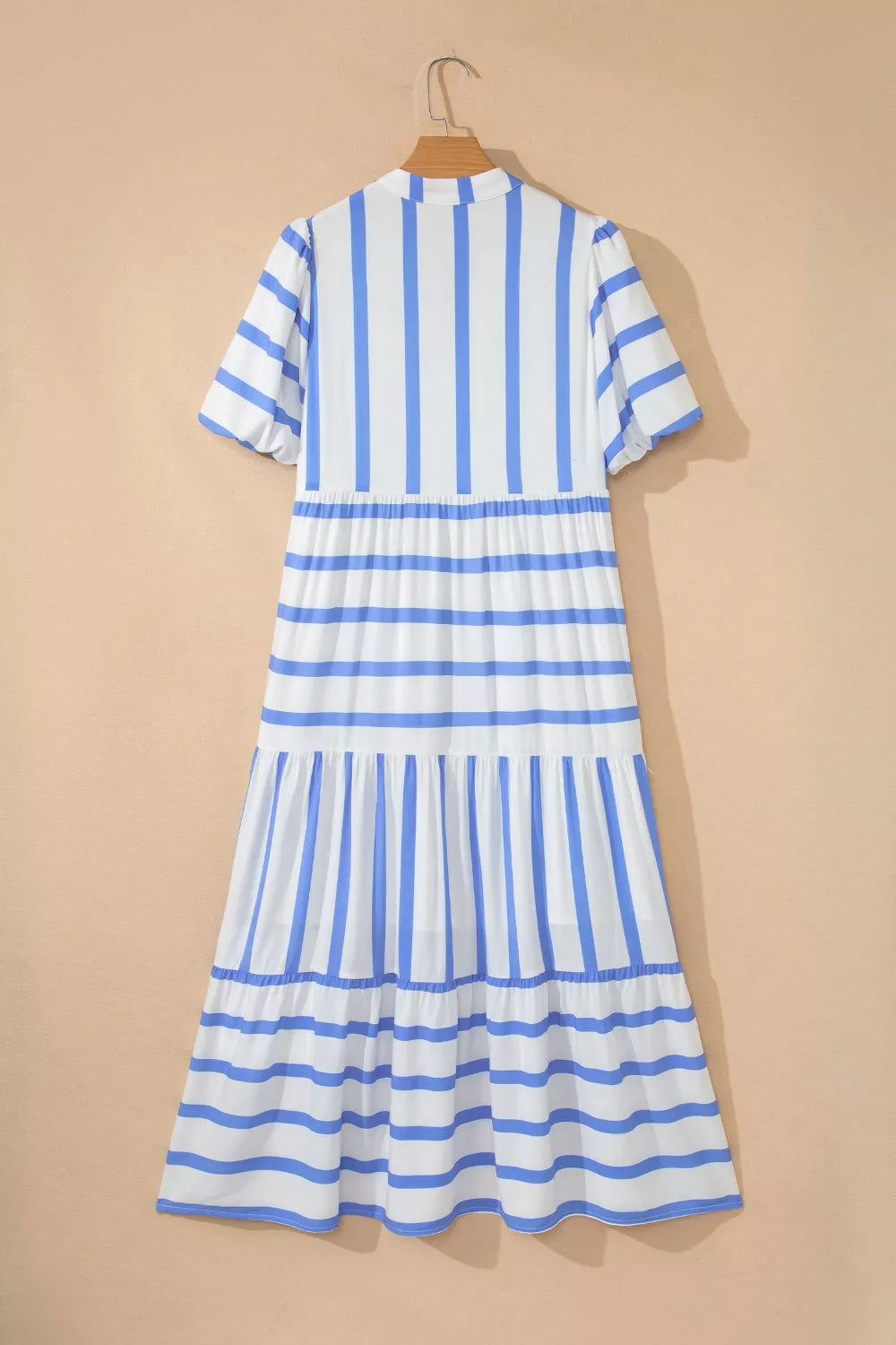 Tiered dress with blue and white stripes, short sleeves, and ruffled hem.