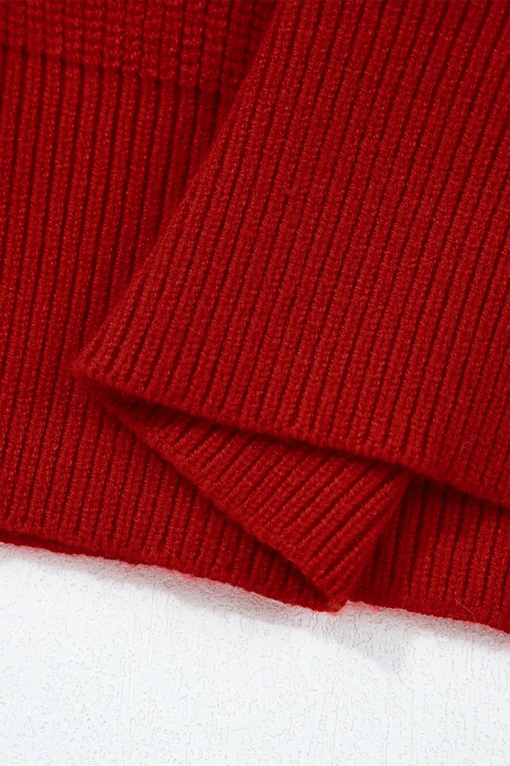 Red ribbed knit sweater with a folded detail.