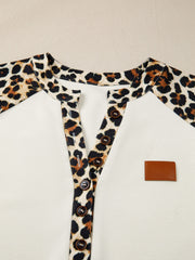 Buttoned blouse with leopard print collar and placket, beige body, and brown buttons.