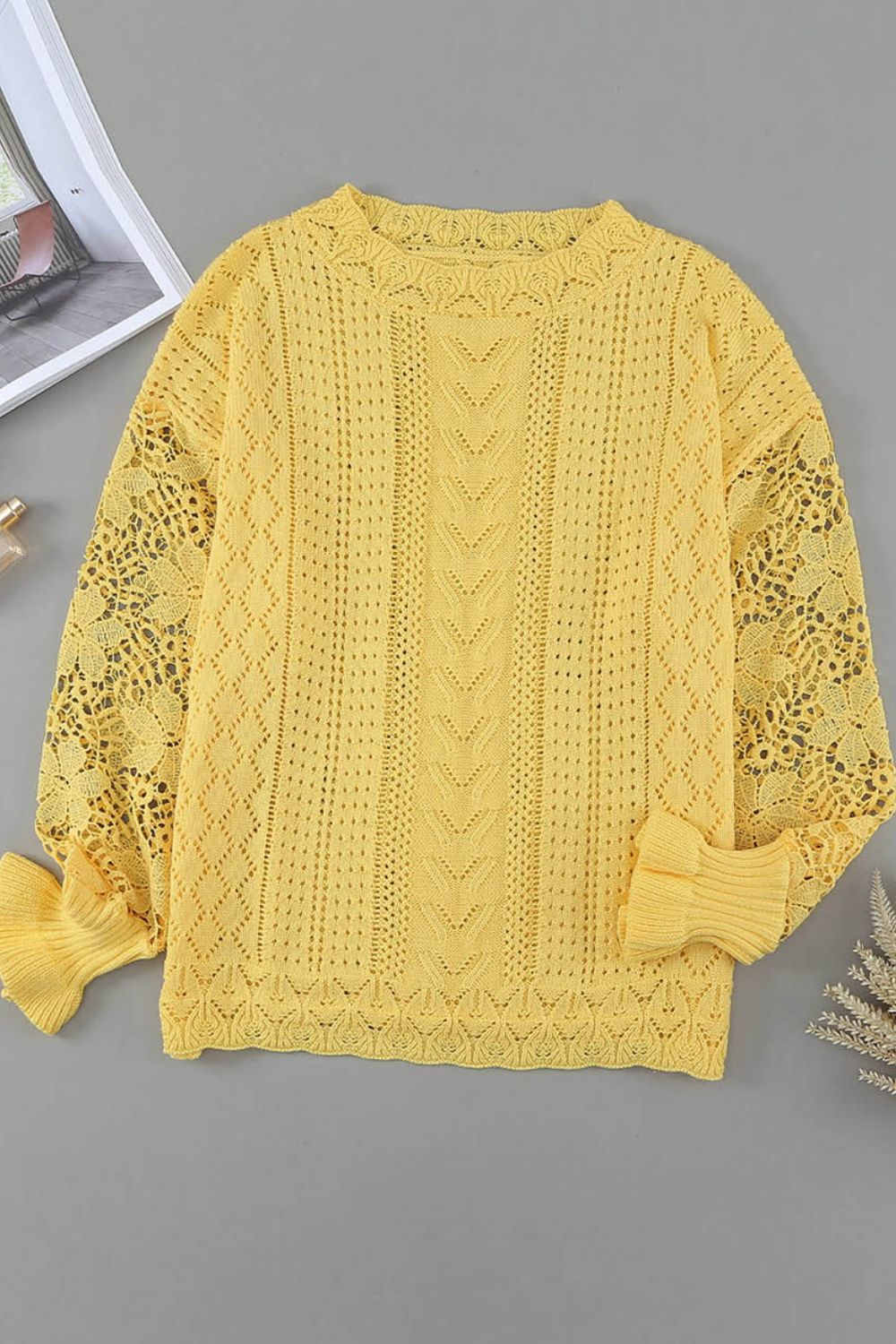Yellow openwork knit sweater with lace sleeves and textured knit details.