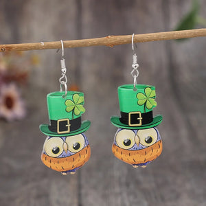 Lucky Owl acrylic dangle earrings in green with shamrock hats and gold buckles.