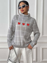 Light gray turtleneck sweater with white grid pattern and three red heart appliqués.