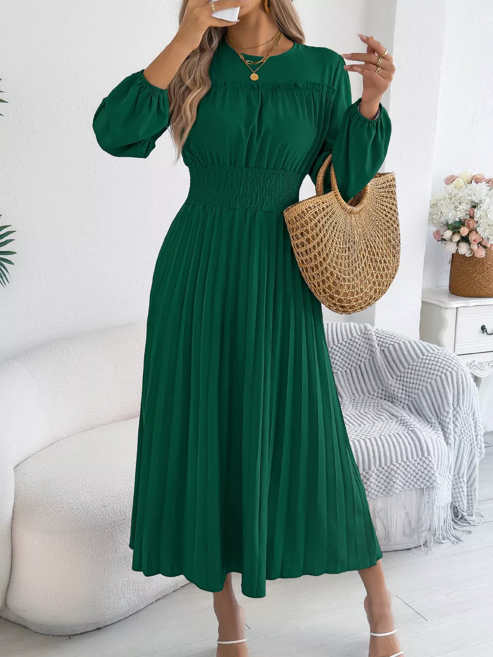 Green midi dress with smocked waist, ruffled bodice, and pleated skirt.