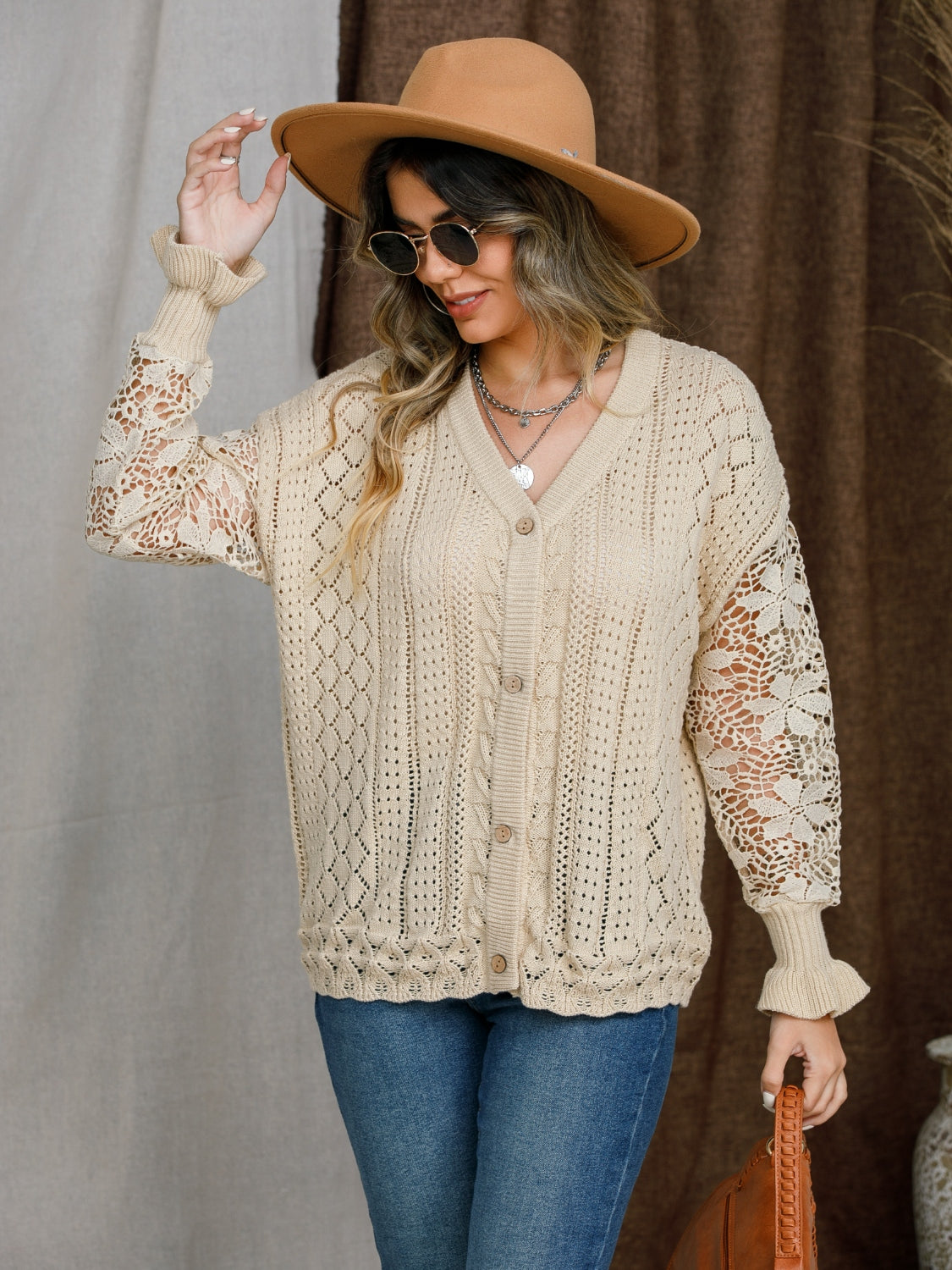 Tan knit cardigan with lace sleeves and button front.