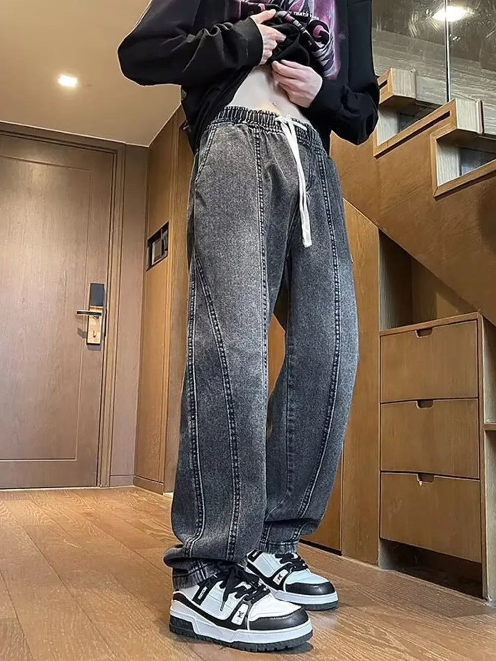 Dark gray vintage wash straight-leg jeans with drawstring waist and contrast stitching.