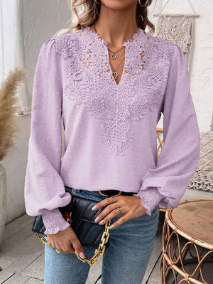 Lilac embroidered yoke blouse with puff sleeves and textured fabric.