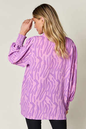 Lavender zebra print blouse with shirred cuffs and balloon sleeves.