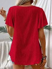 Red embroidered square neck blouse with flutter sleeves and textured fabric.