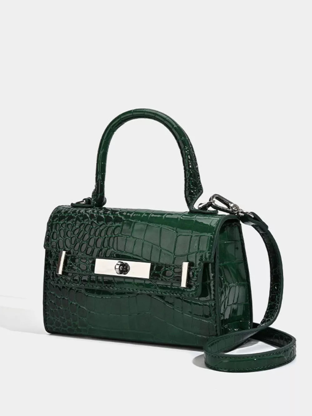 Green croc-embossed small tote bag with silver hardware and adjustable strap.