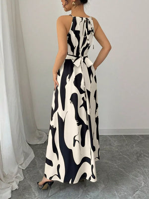Chic halter neck maxi dress with abstract print and tie waist in white and black.