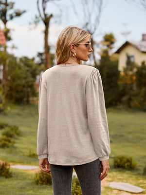 Dusty purple ruffled henley sleeve blouse with gathered shoulder detail.