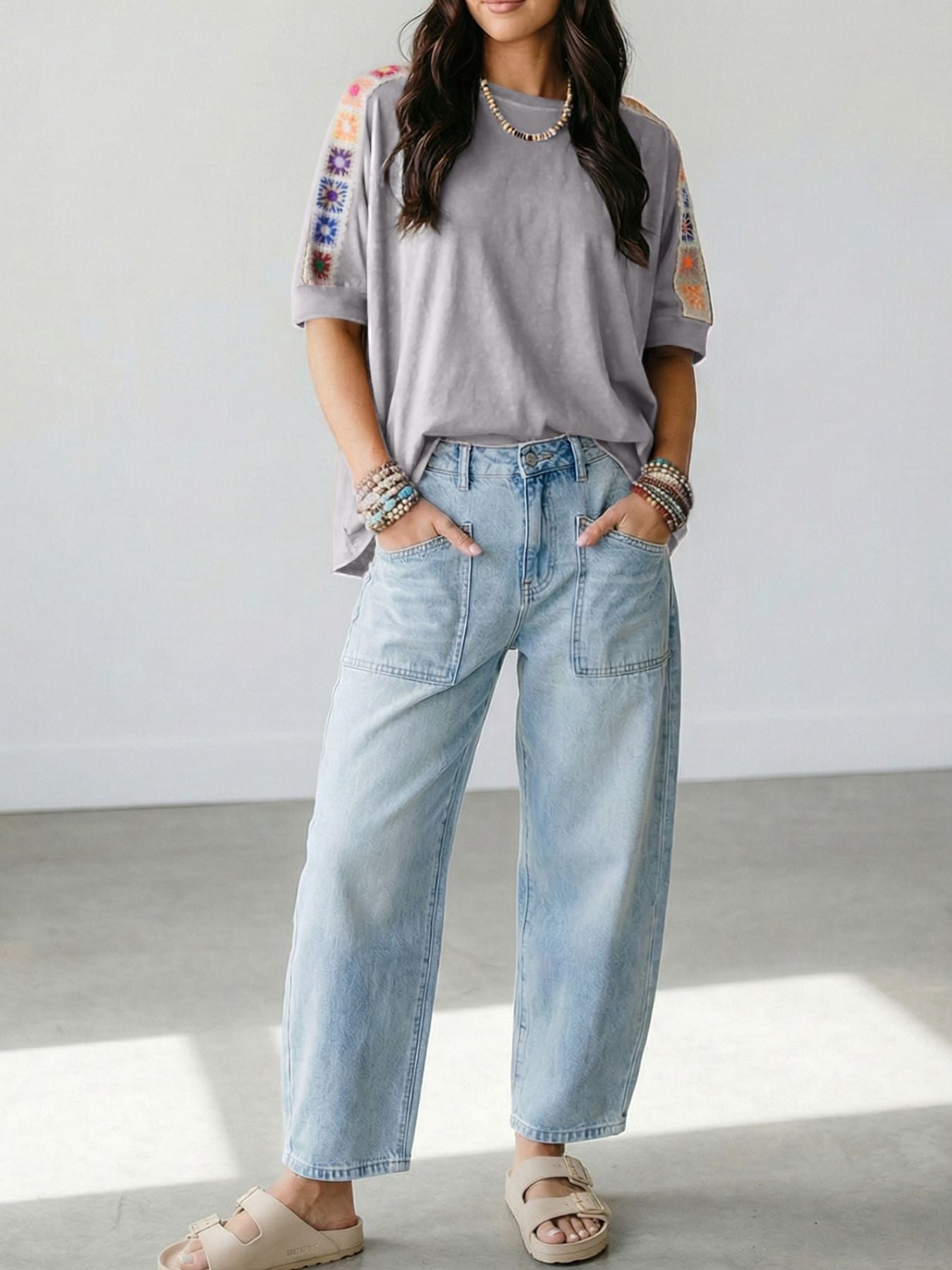 Grey t-shirt with colorful crochet detail on sleeves, loose fit, crew neck.