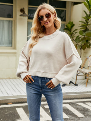 Dropped shoulder knit sweater in cream with balloon sleeves and a relaxed fit.