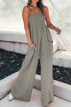Gray smocked bodice palazzo jumpsuit with wide legs and pockets.