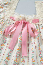 Floral mini dress with lace trim, pink bows, and a floral stripe print.