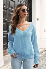 Light blue acrylic V-neck sweater with vertical ribbing detail and long sleeves.