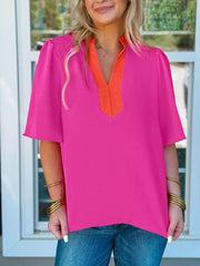 Textured pink blouse with orange V-neck detail and half sleeves.