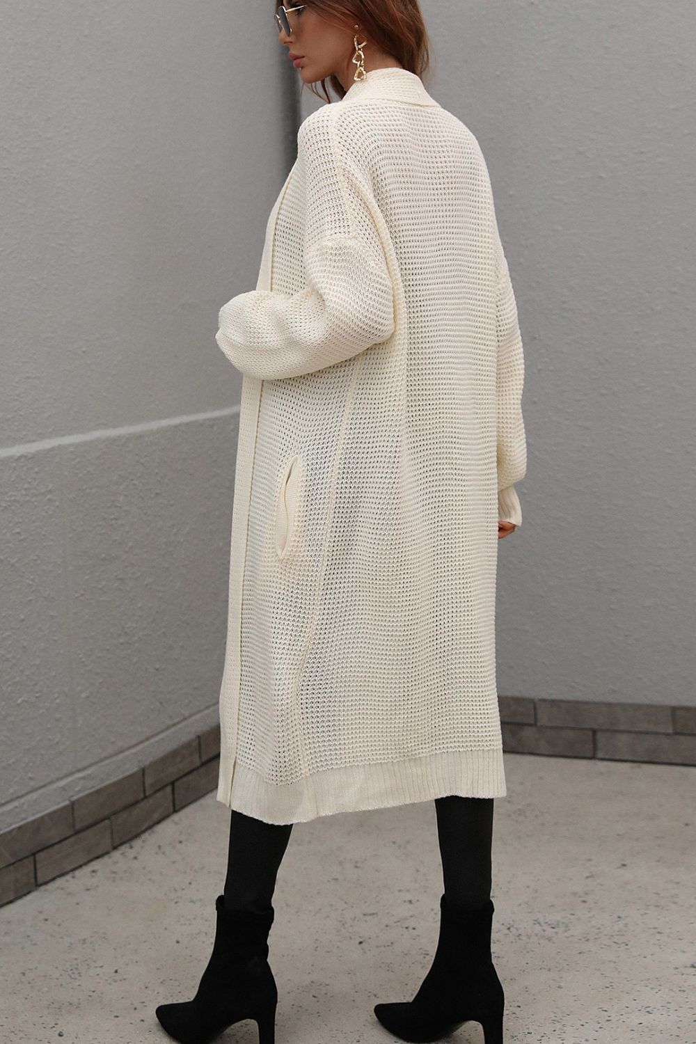 Cream textured knit maxi cardigan with pockets and a relaxed fit.