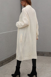 Cream textured knit maxi cardigan with pockets and a relaxed fit.