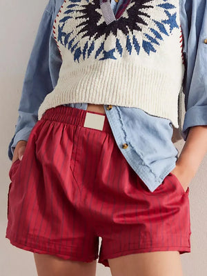 Scarlet boxer shorts with subtle vertical pinstripes and an elastic waistband.