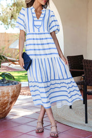 White and blue striped tiered midi dress with ricrac trim and puff sleeves.
