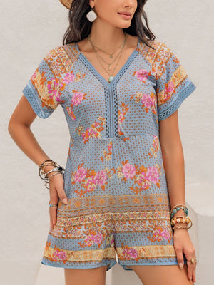 Light blue floral embroidered romper with V-neck and cutout detail.