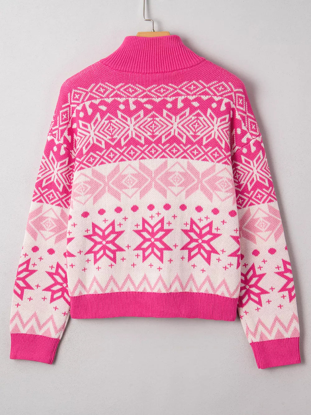 Women's pink Fair Isle knit quarter zip sweater with snowflake pattern.