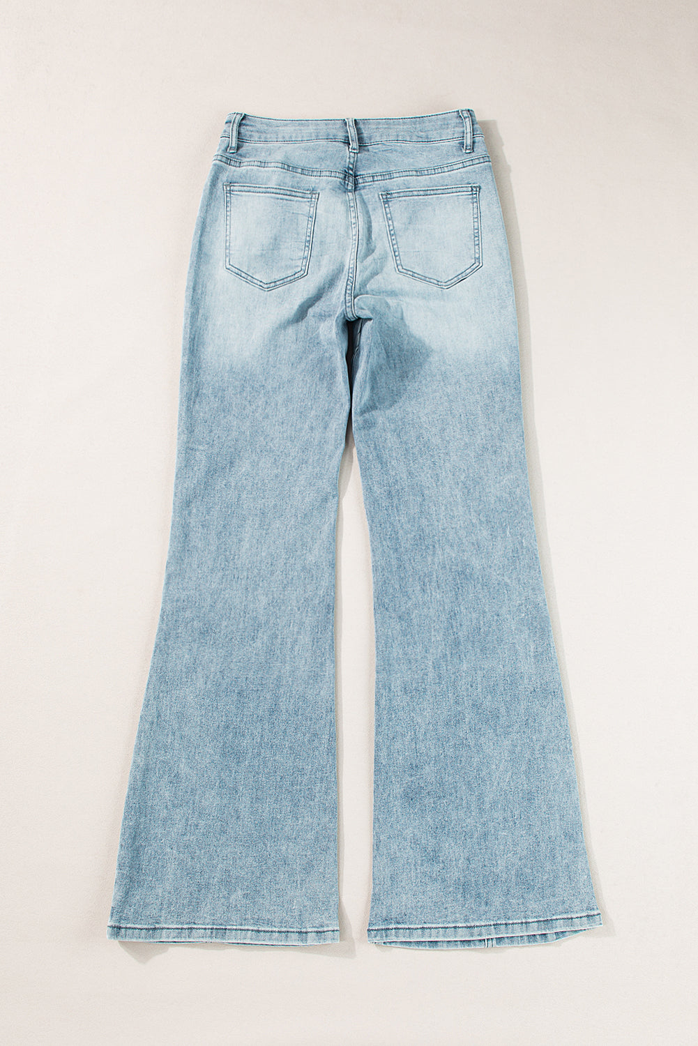 High-waisted palazzo flare denim jeans in medium wash, showing back pockets and flared legs.