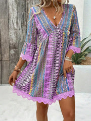 Bohemian printed v-neck dress with bell sleeves and lace trim in light purple.