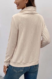 Beige textured cowl neck drawstring knit sweater with long sleeves.