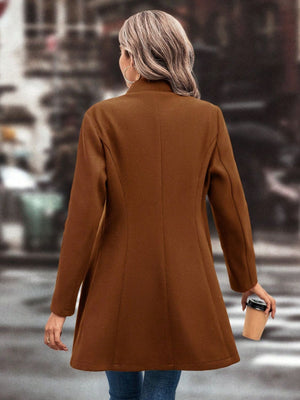 Caramel wool coat with flared hemline and button detail.