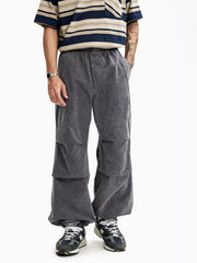 Grey relaxed fit cargo pants with elastic waist and layered knee detail.